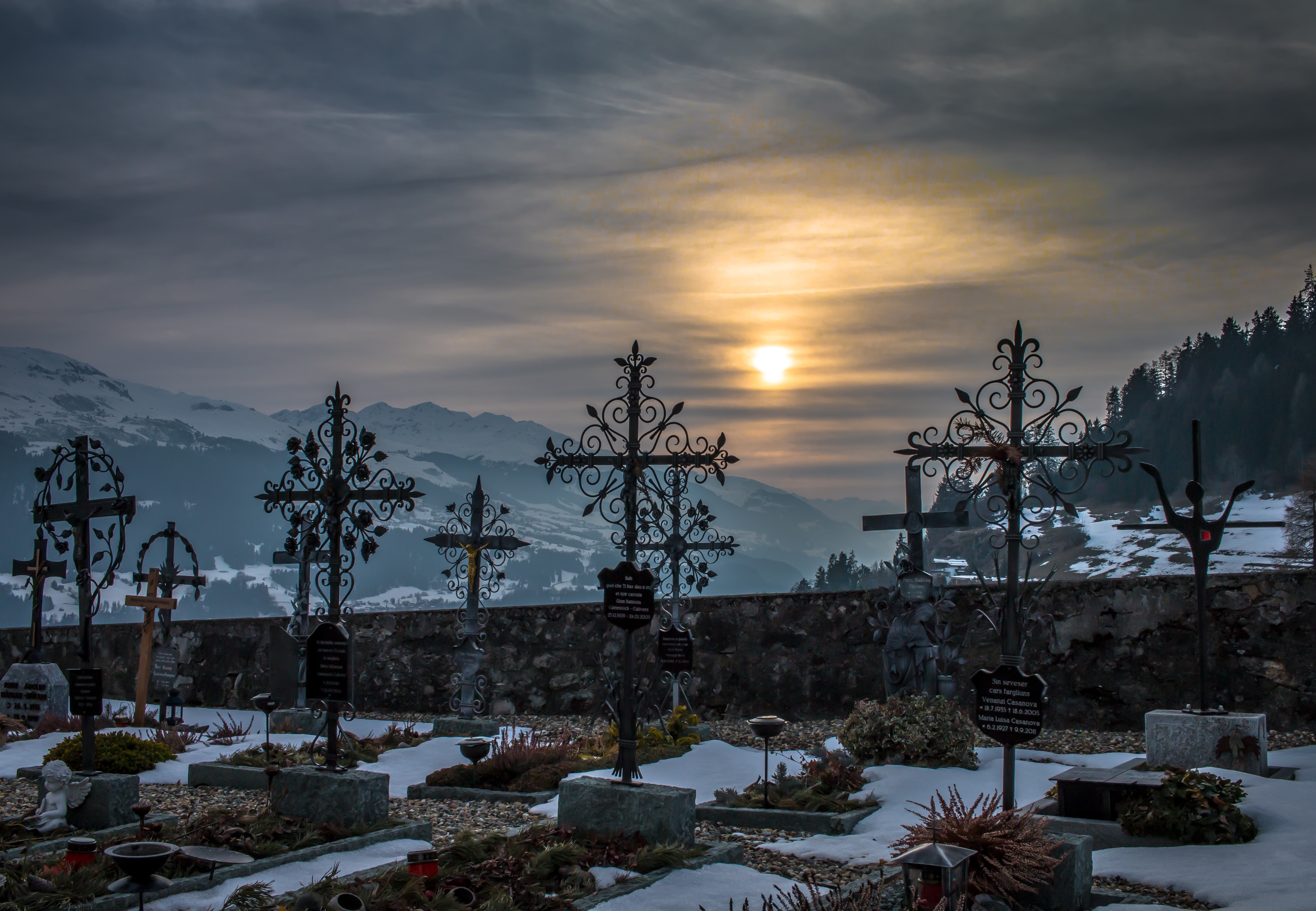 grave near mountain covered with snow during sunset