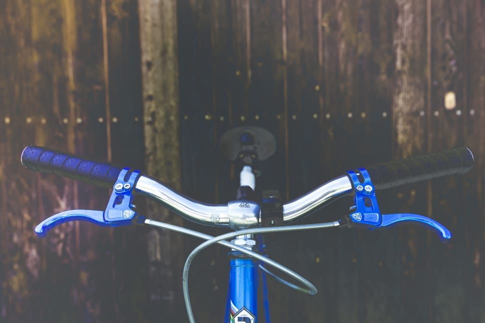 blue and gray bike near brown wooden wall preview