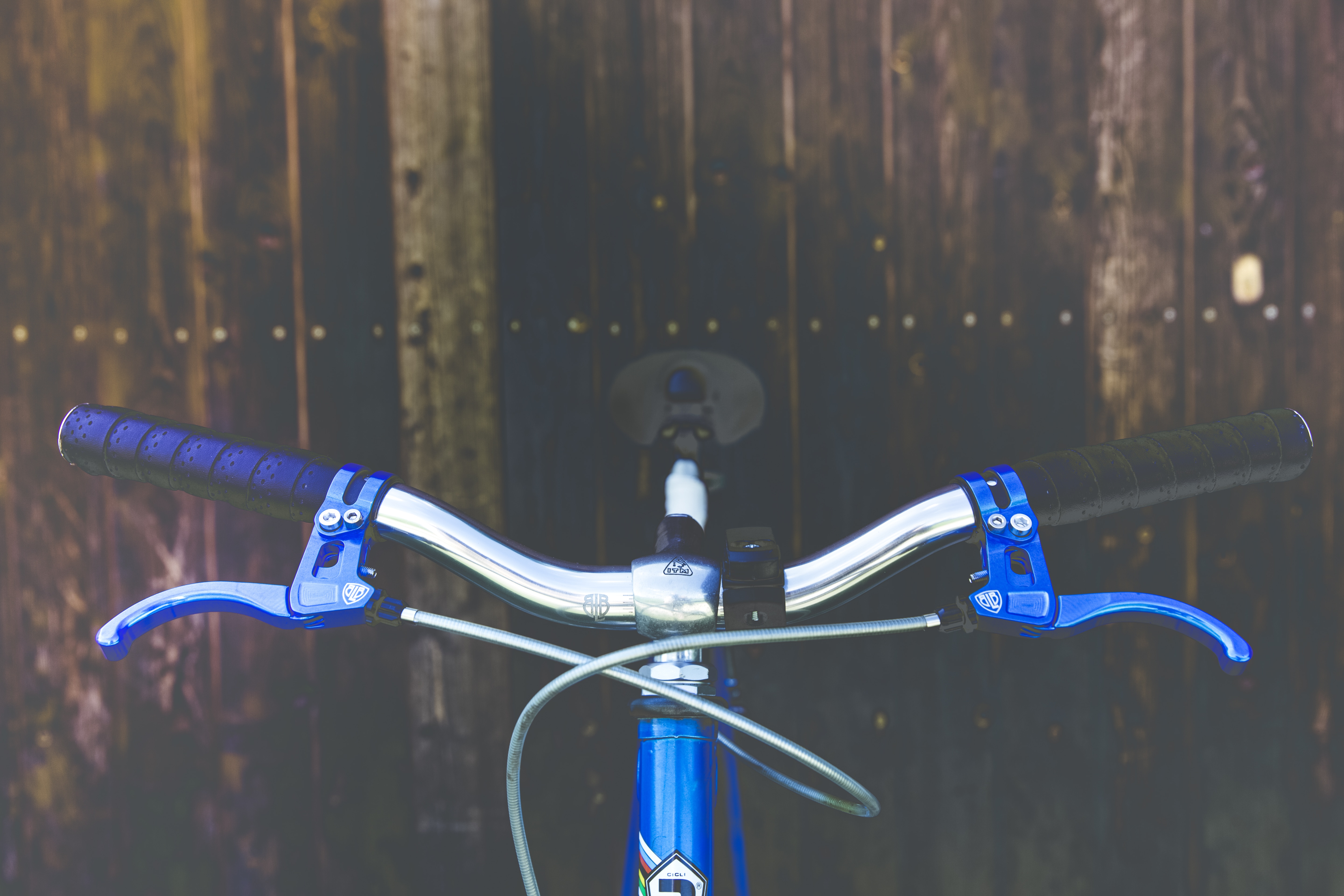 blue and gray bike near brown wooden wall