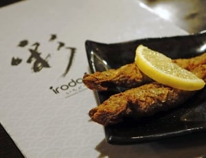 fried fish with sliced lemon thumbnail