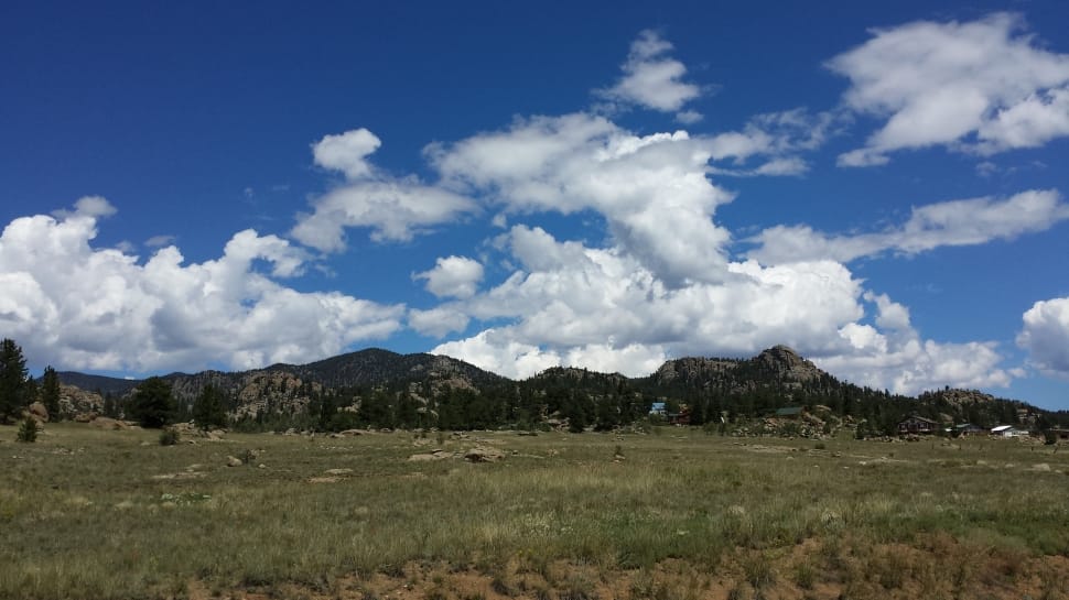 brown mountains under white clouds during daytime preview