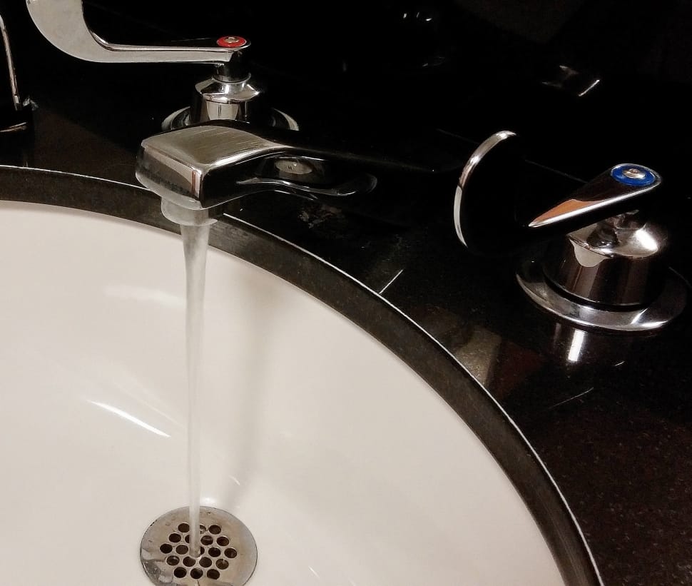 stainless steel faucet flowing water preview