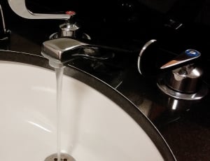 stainless steel faucet flowing water thumbnail