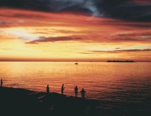 silhouette of people on the seashore thumbnail