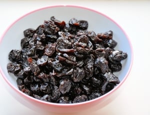 raisins on pink and white ceramic bowl thumbnail