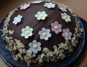 round brown and black floral baked food in tray thumbnail