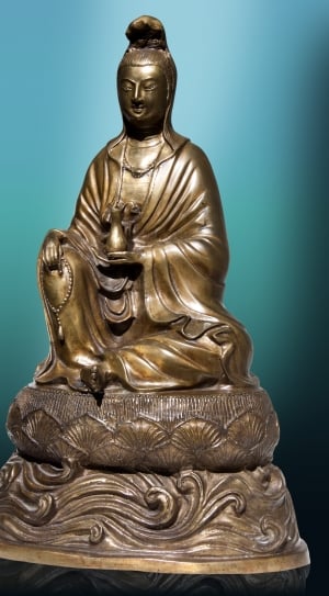 brown ceramic man holding pitcher and praying beads figurine thumbnail