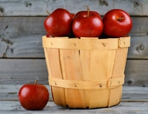 red apples and wooden basket thumbnail
