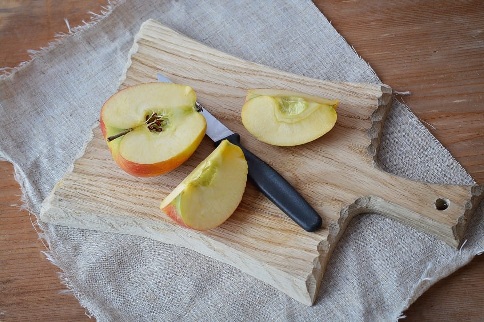sliced apple beside knife and chopping board preview