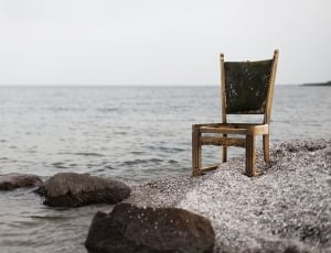 brown wooden chair near seashore thumbnail