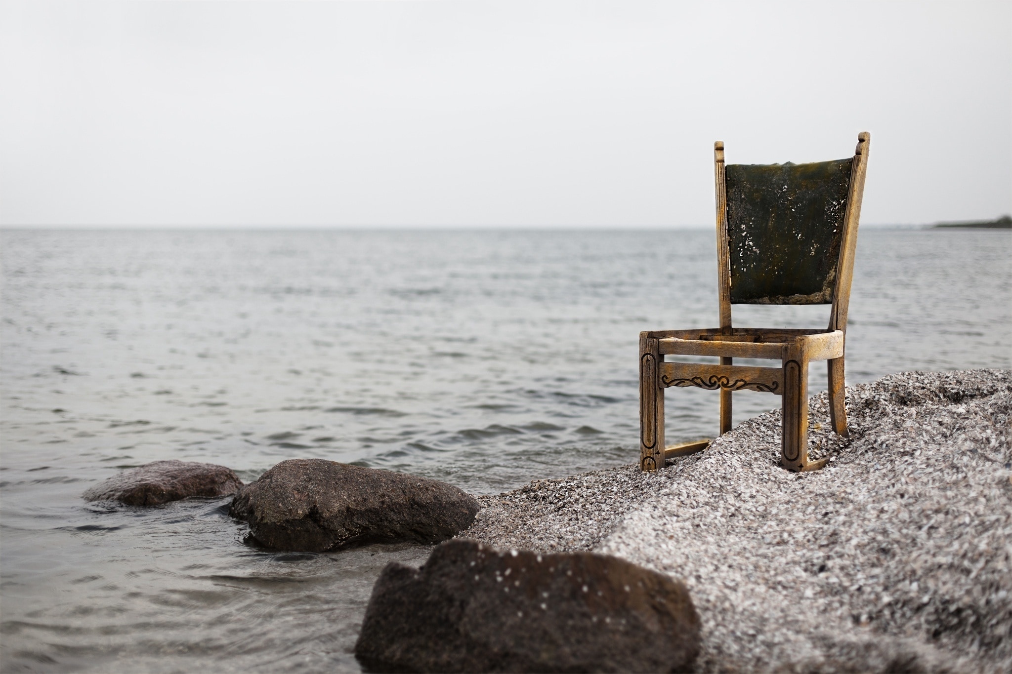 brown wooden chair near seashore