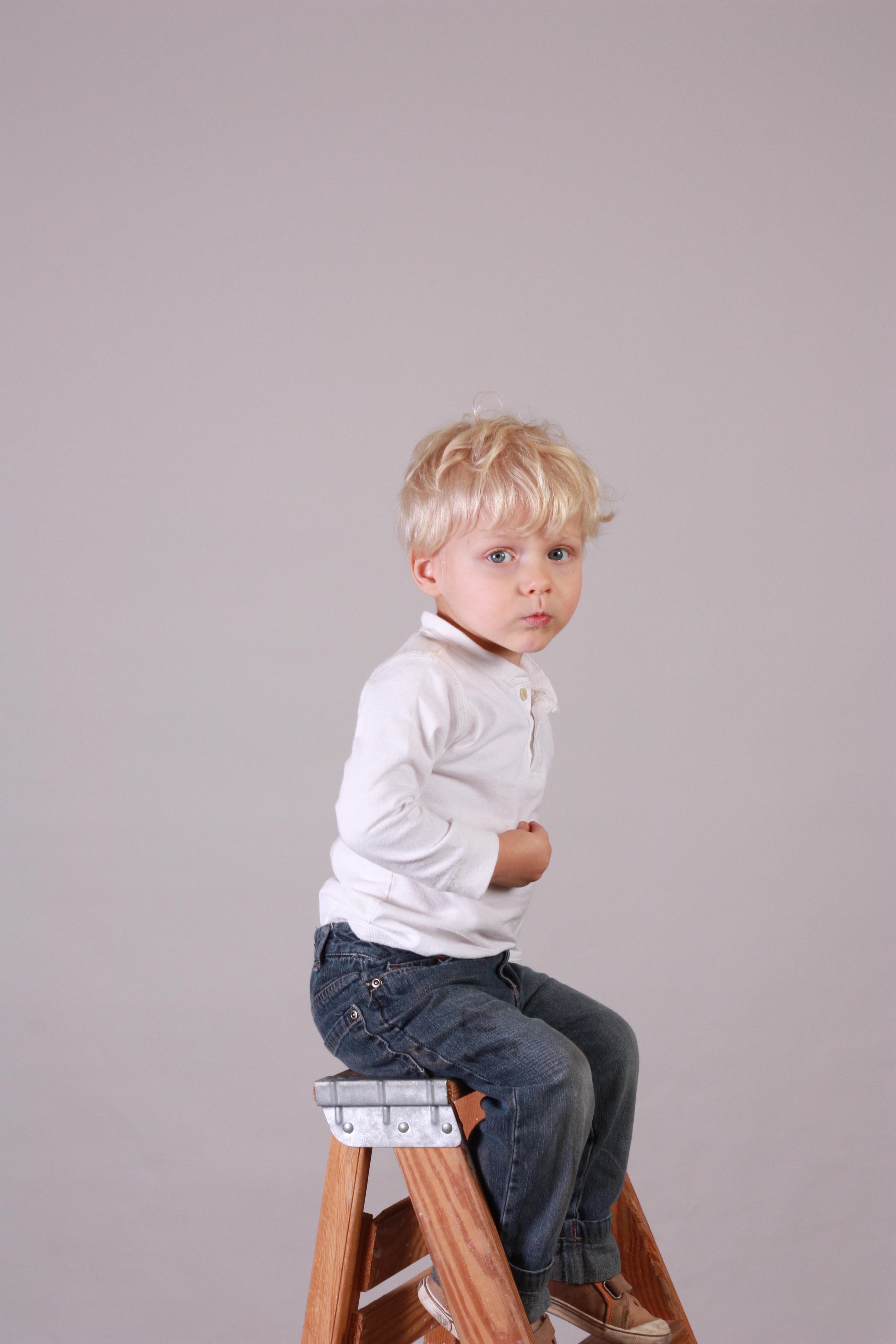 boy's white dress shirt and blue denim pants outfit