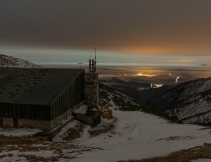 photo of snowy field with cabin during dusk thumbnail
