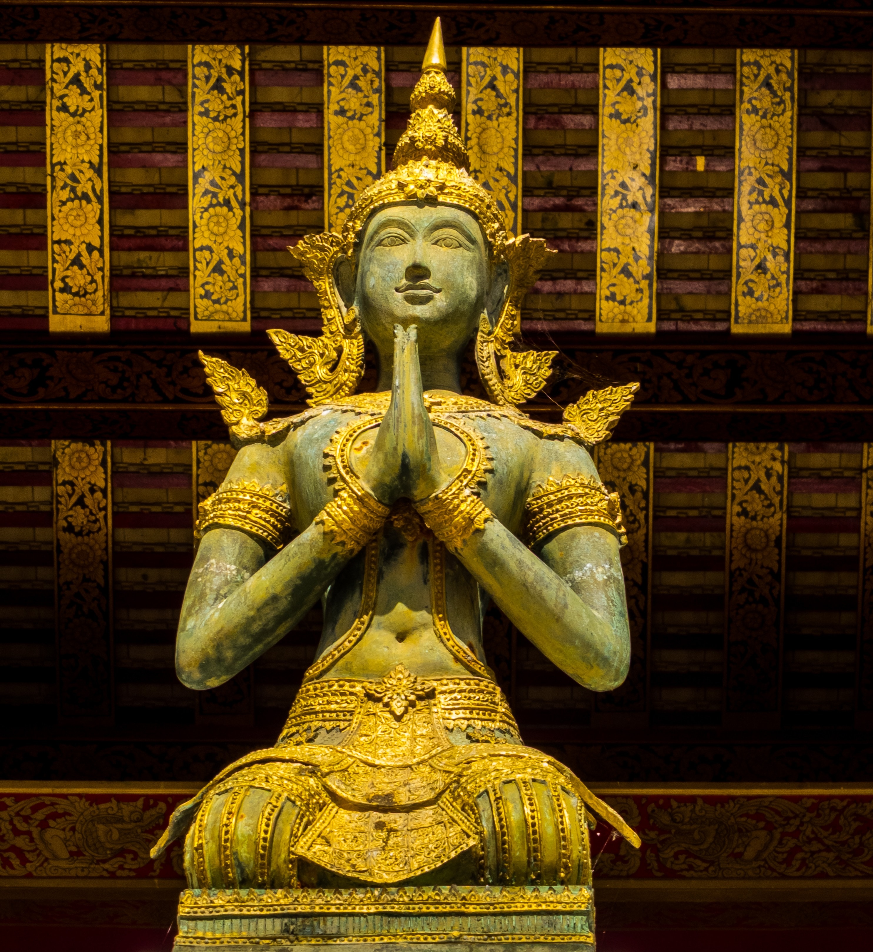 grey and gold deity statue