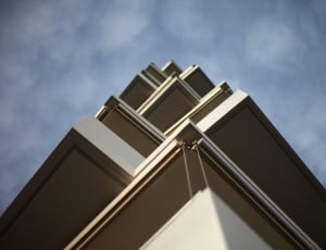grey high rise building under blue sky low angle photography thumbnail