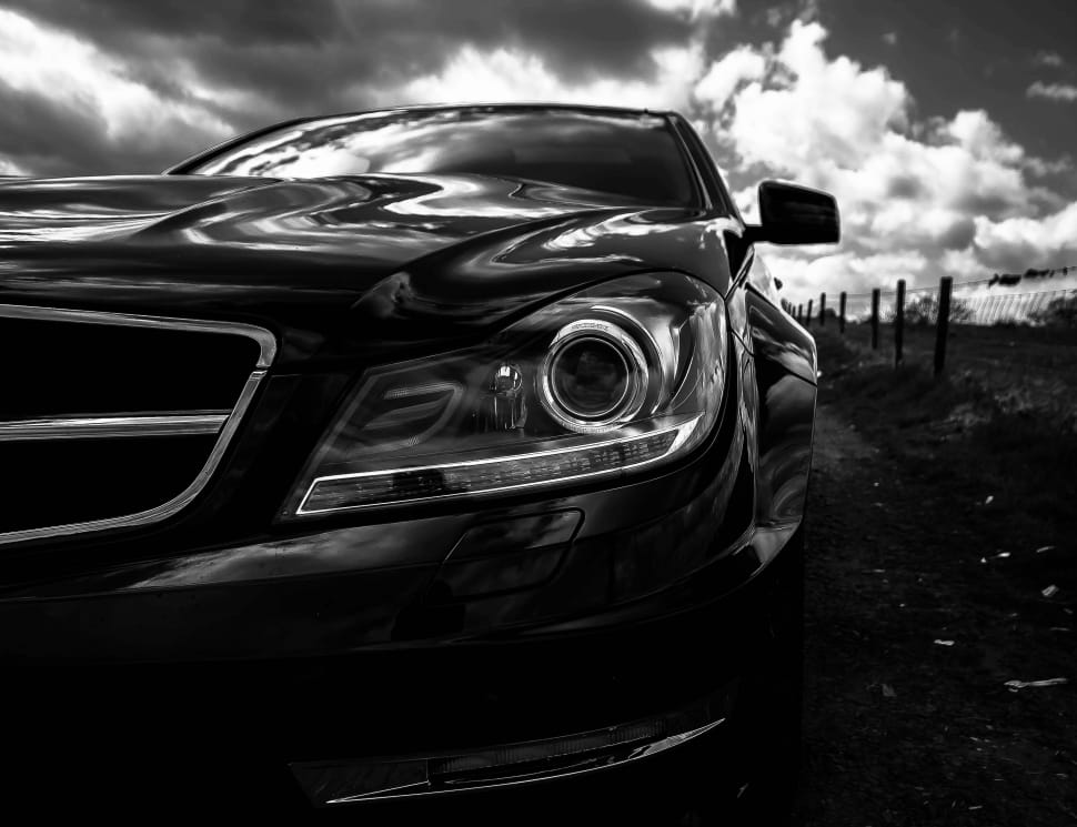 black car under the cloudy sky during daytime preview