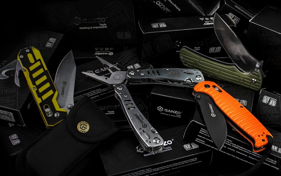 orange pocketknife next to a pliers preview