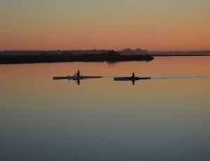 2 person rowing a boat at sunset thumbnail