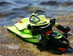 black and green diving gear set on brown concrete thumbnail