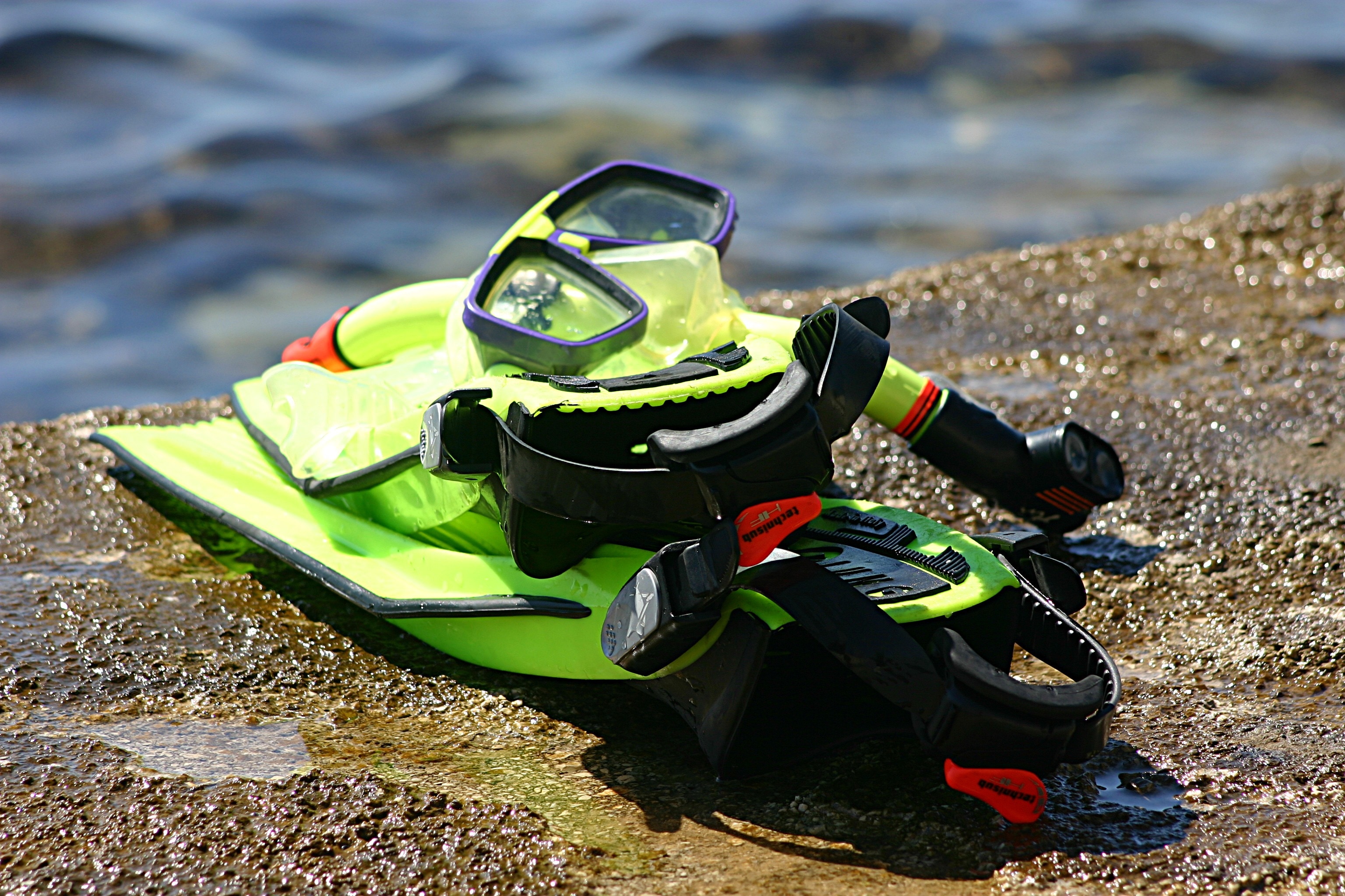 black and green diving gear set on brown concrete