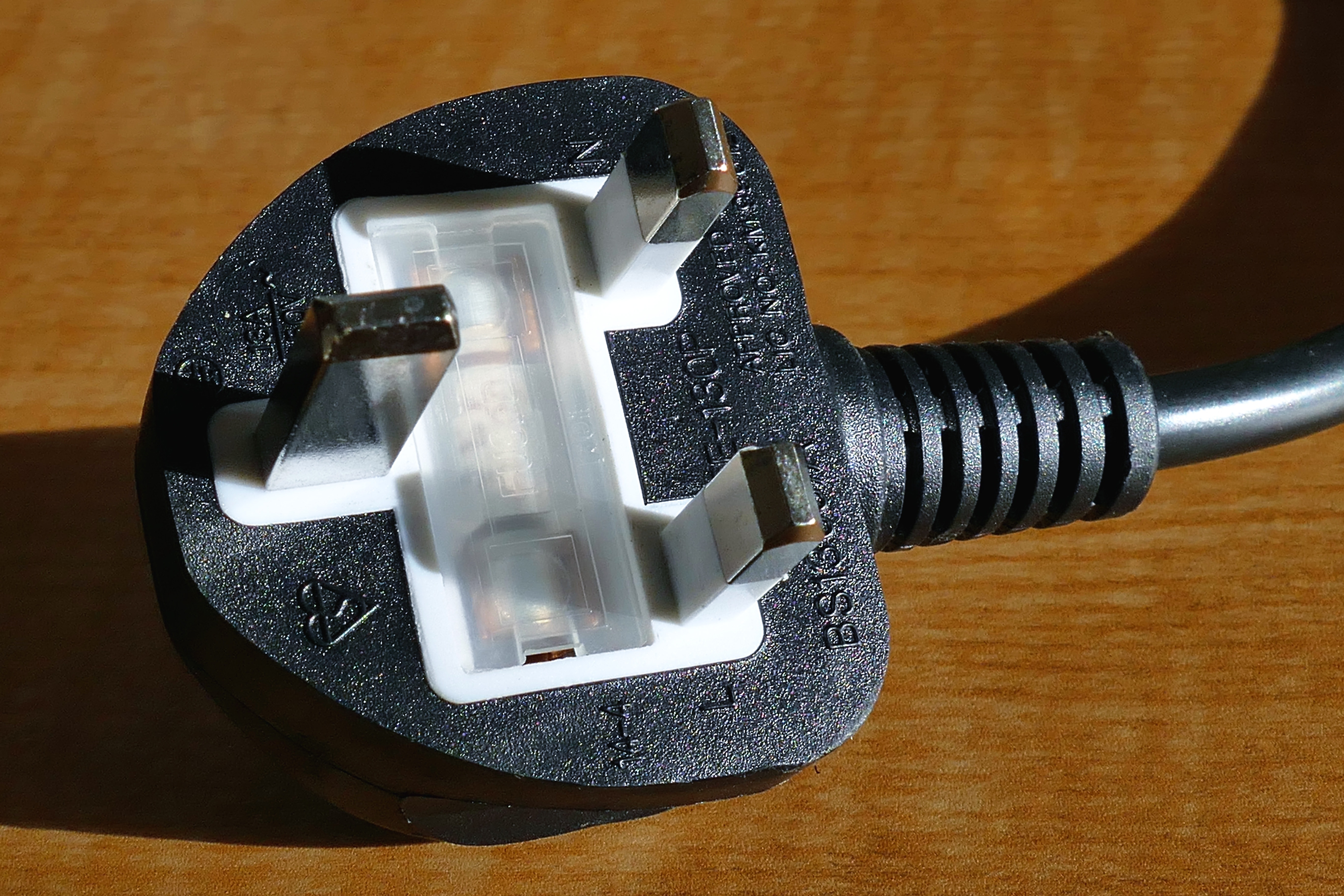 black and white electrical plug with grounding pin