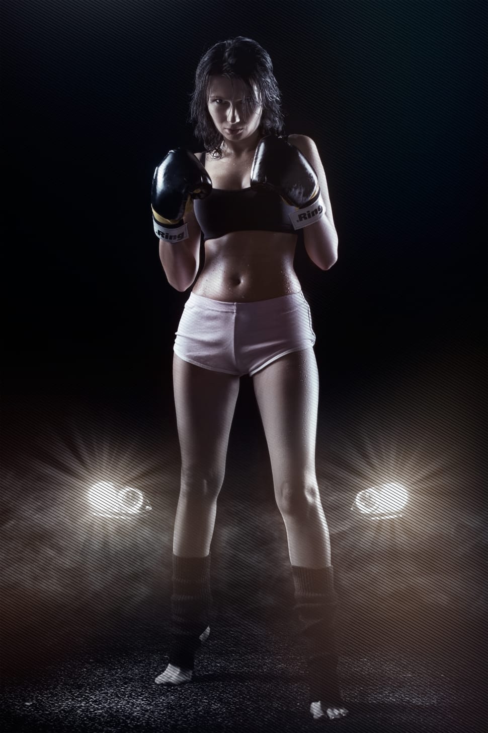Woman wearing white and red sports bra and black boxing gloves