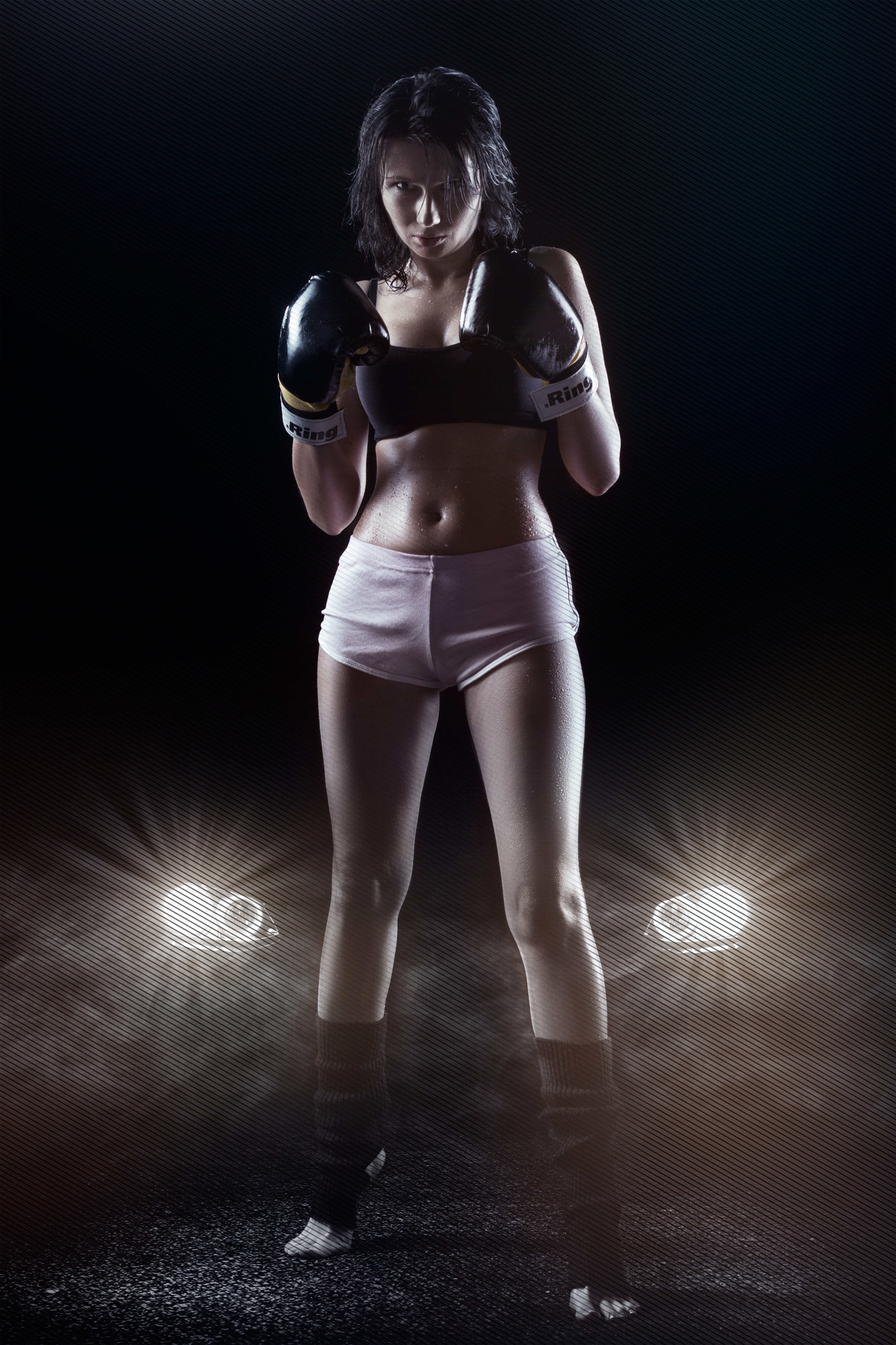 woman in white shorts black sports bra and black boxing gloves