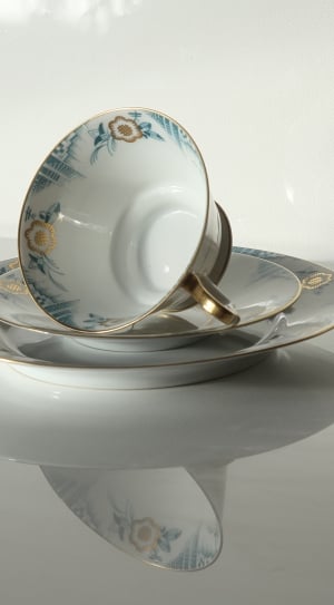 white blue and brown floral ceramic teacup and saucer thumbnail