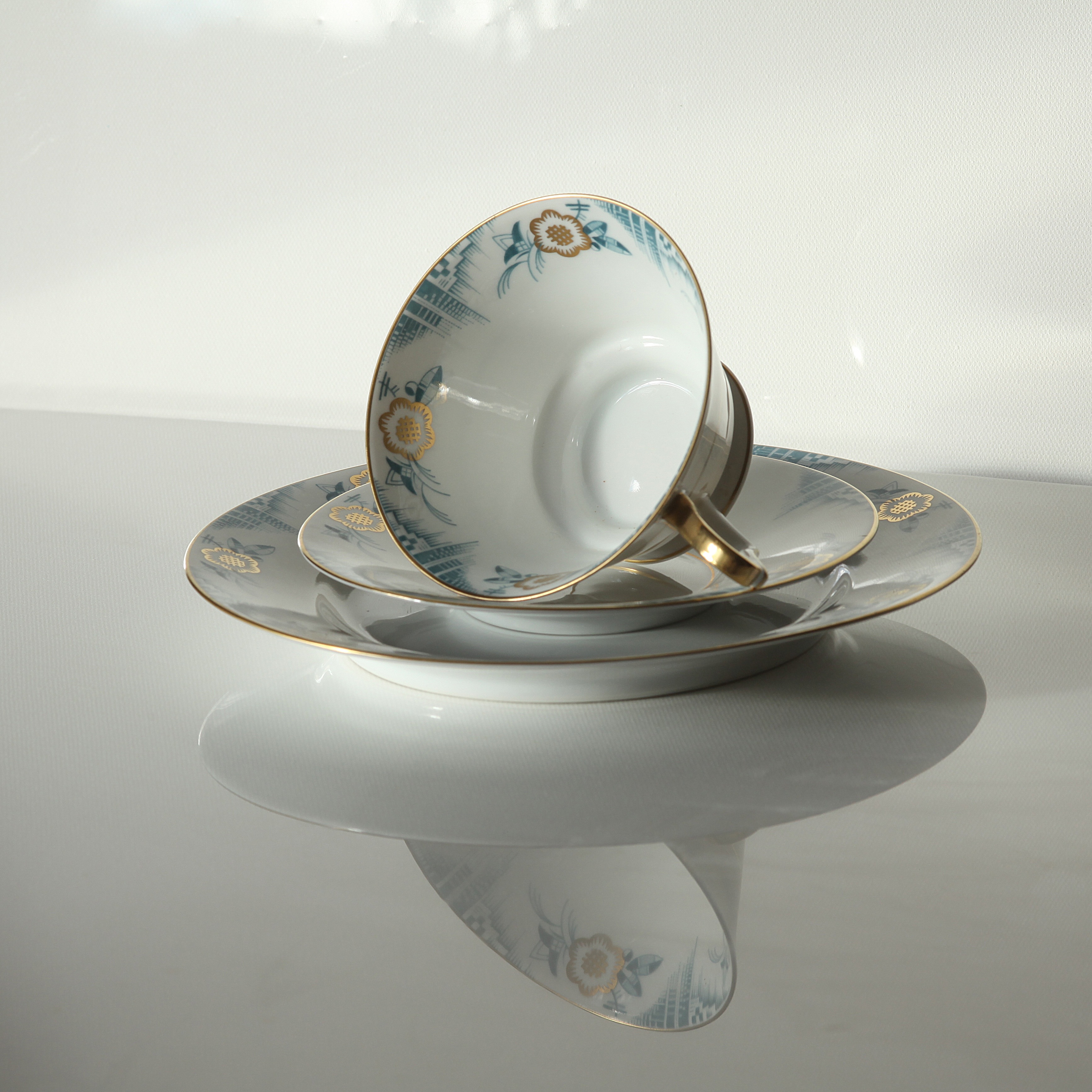 white blue and brown floral ceramic teacup and saucer