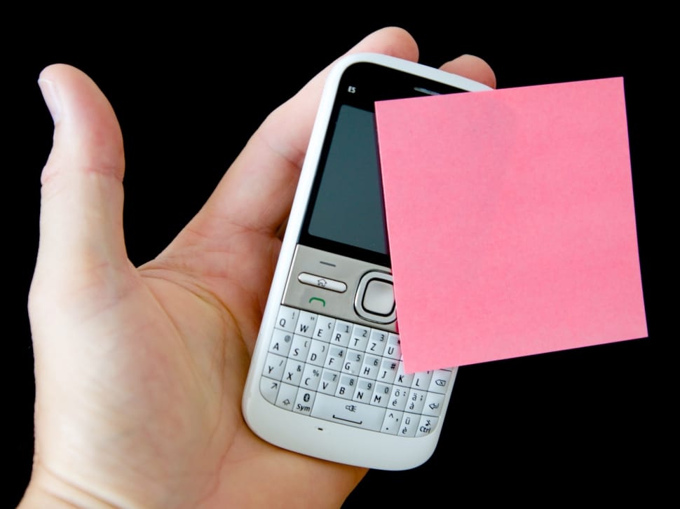person holding white qwerty phone preview