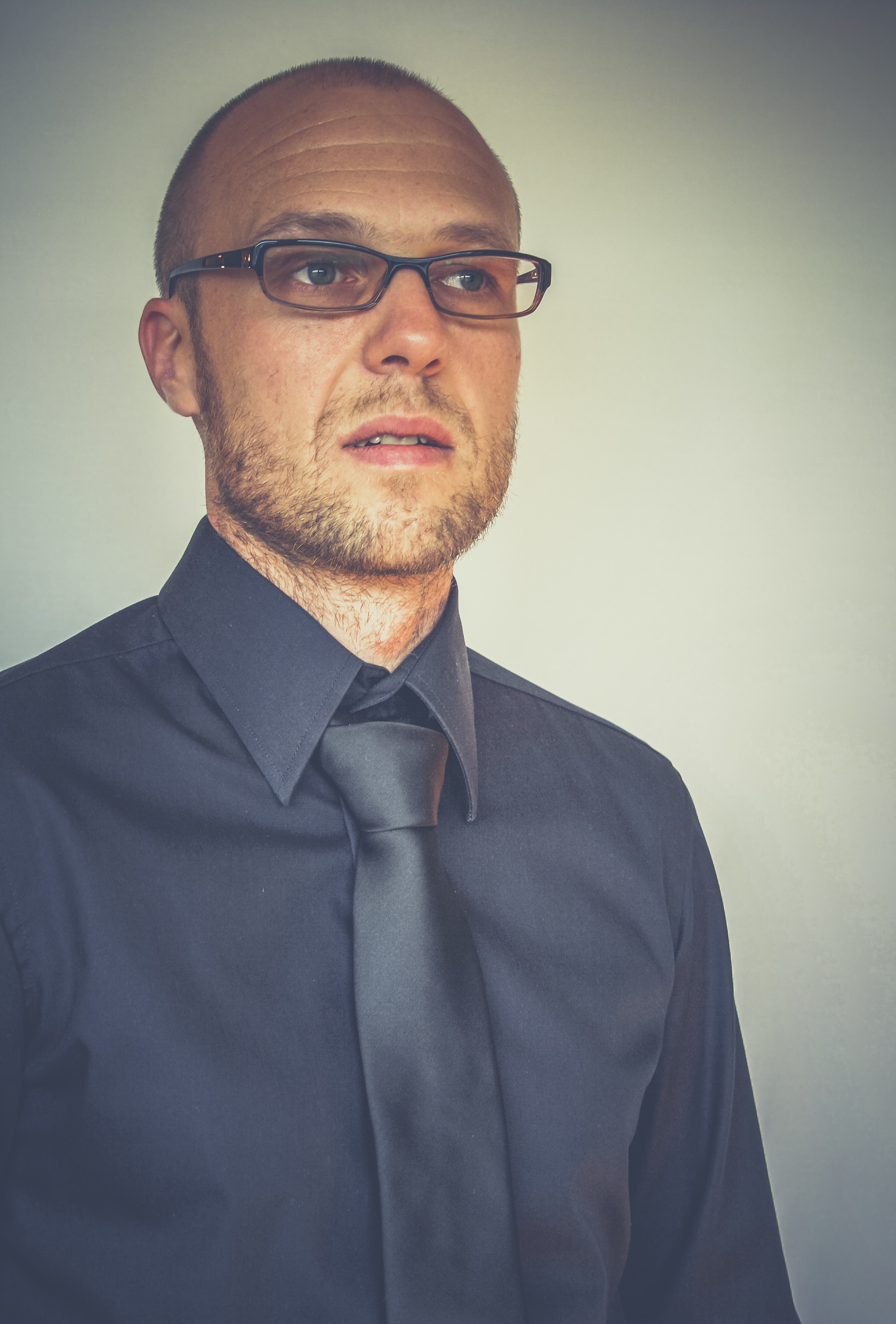 man in black suit and black framed eyeglasses