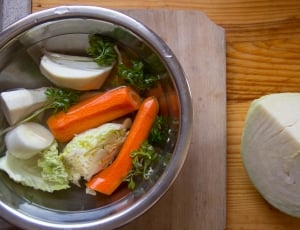 sliced and peeled carrots with cabbages and green leaves thumbnail