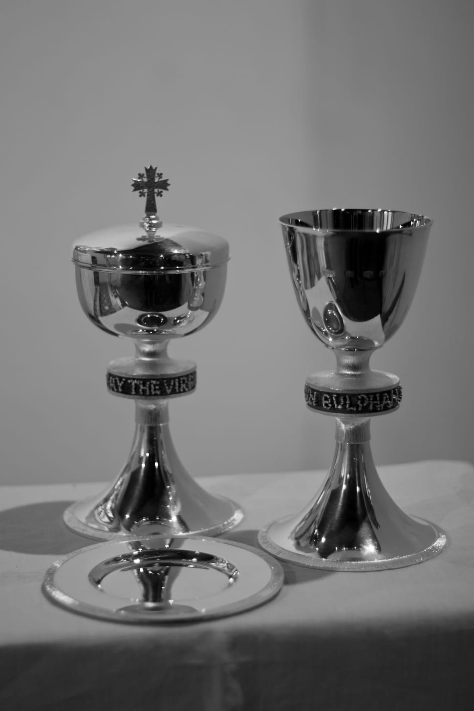 two silver chalices on white surface preview