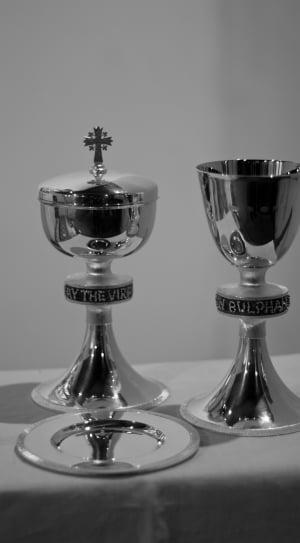 two silver chalices on white surface thumbnail
