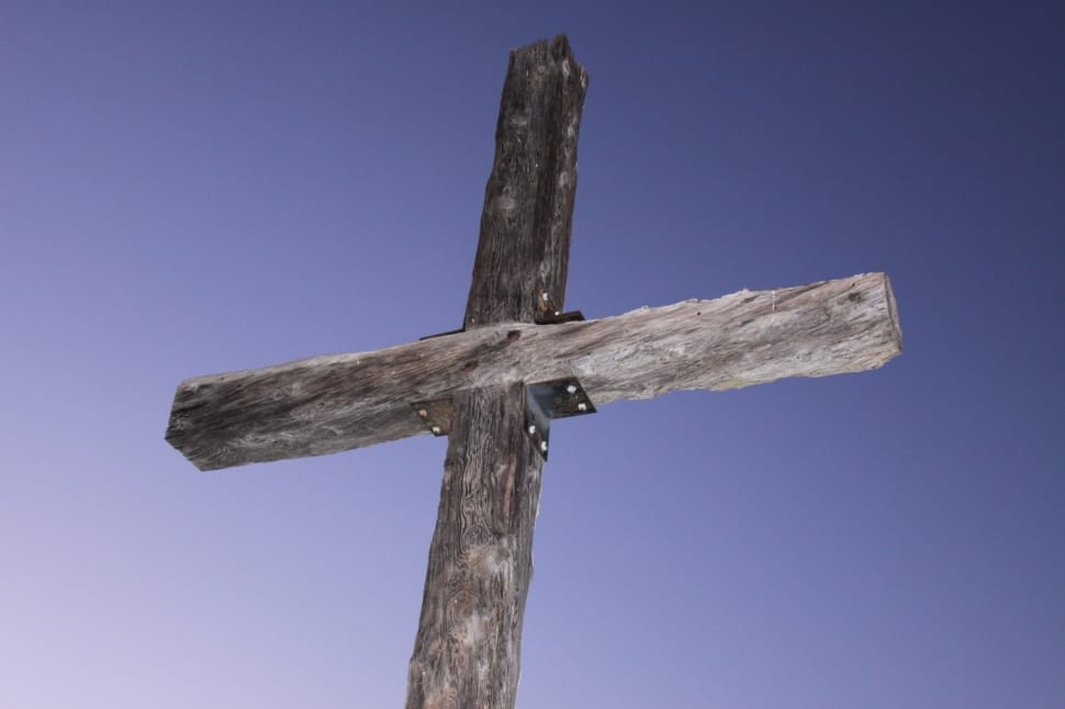 low angle photography of gray wooden cross preview