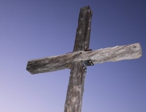 low angle photography of gray wooden cross thumbnail