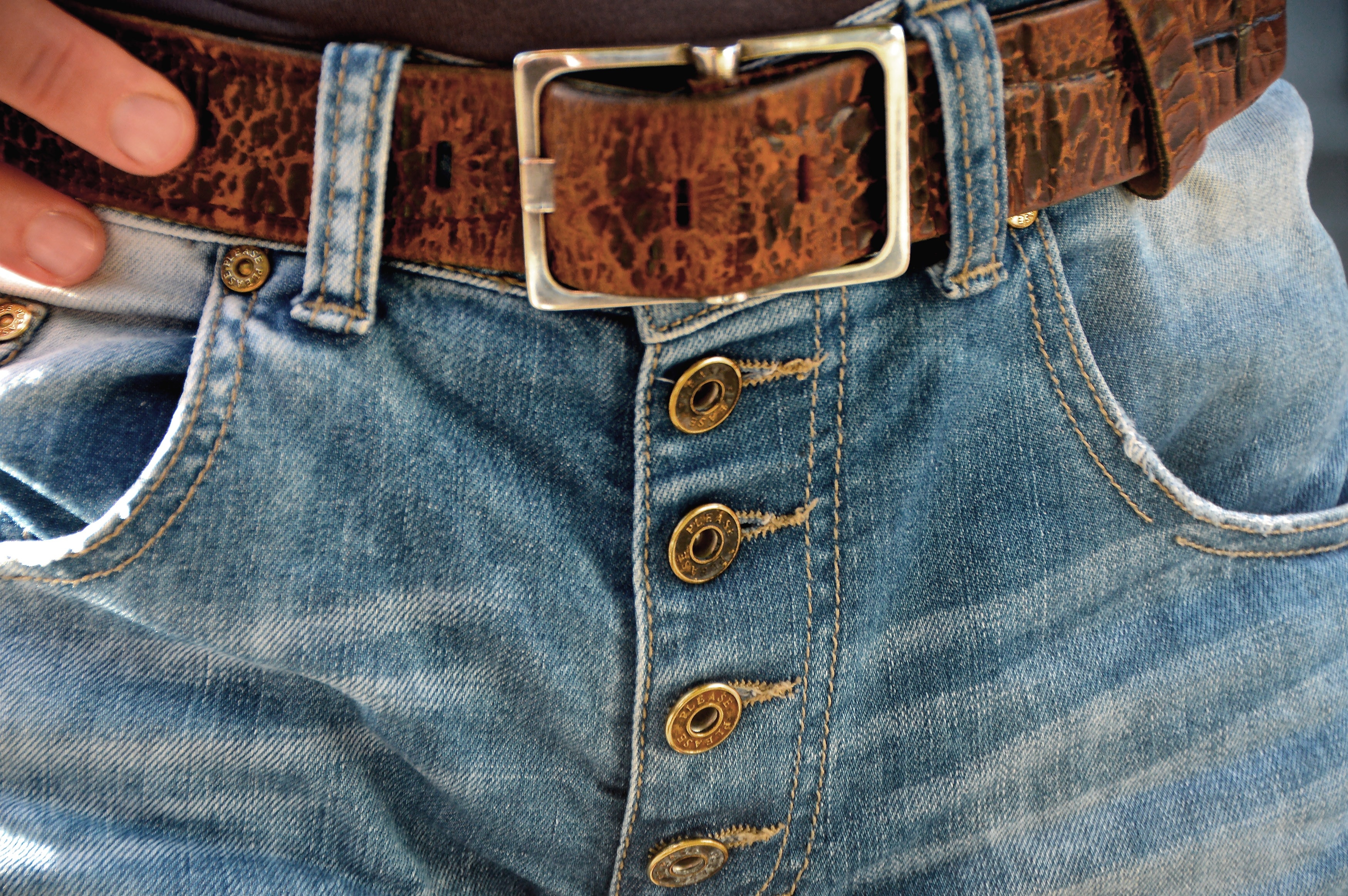blue faded jeans and brown leather belt