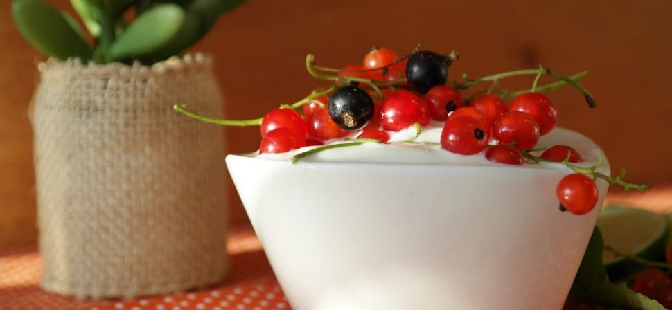 blue and red berries on white ceramic cup with content preview