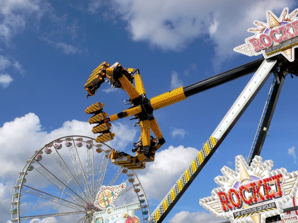 yellow and black carnival ride during day preview