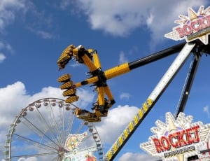 yellow and black carnival ride during day thumbnail