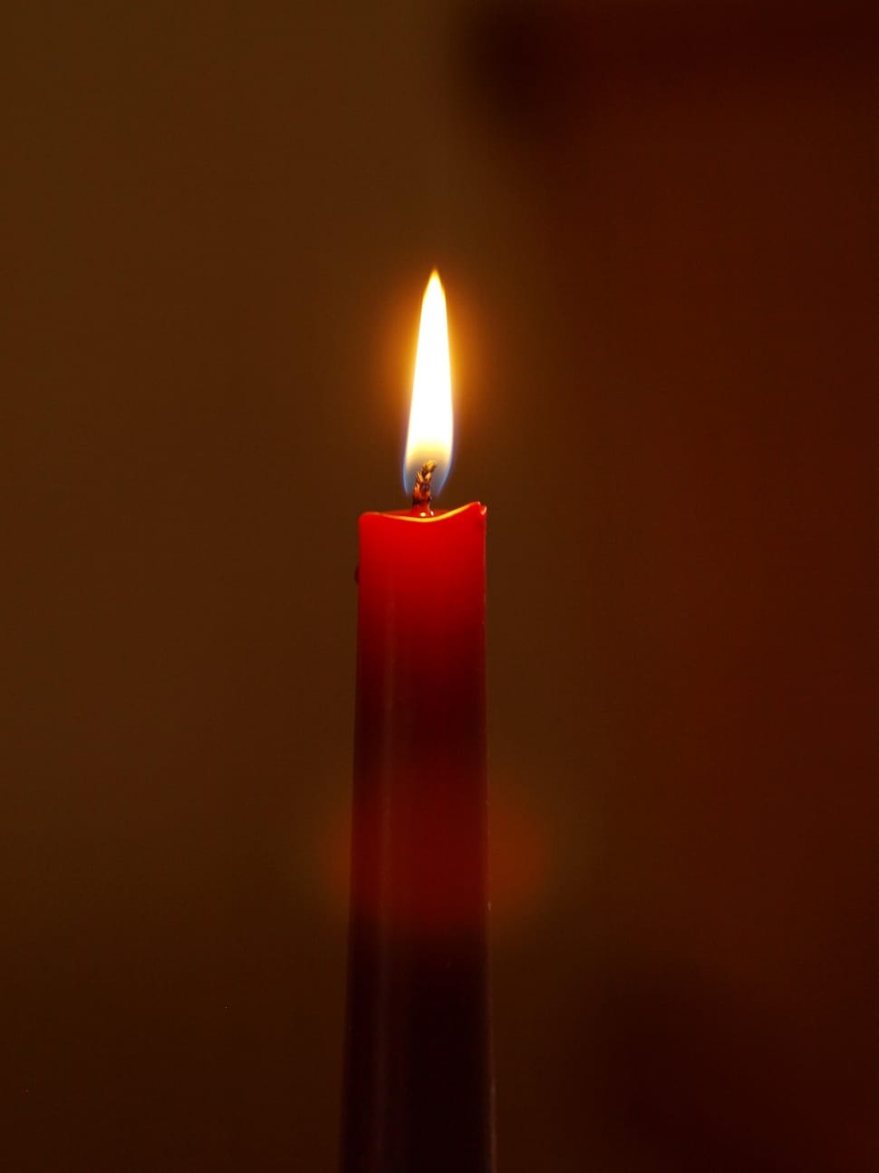 lighted red taper candle preview