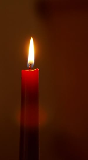 lighted red taper candle thumbnail