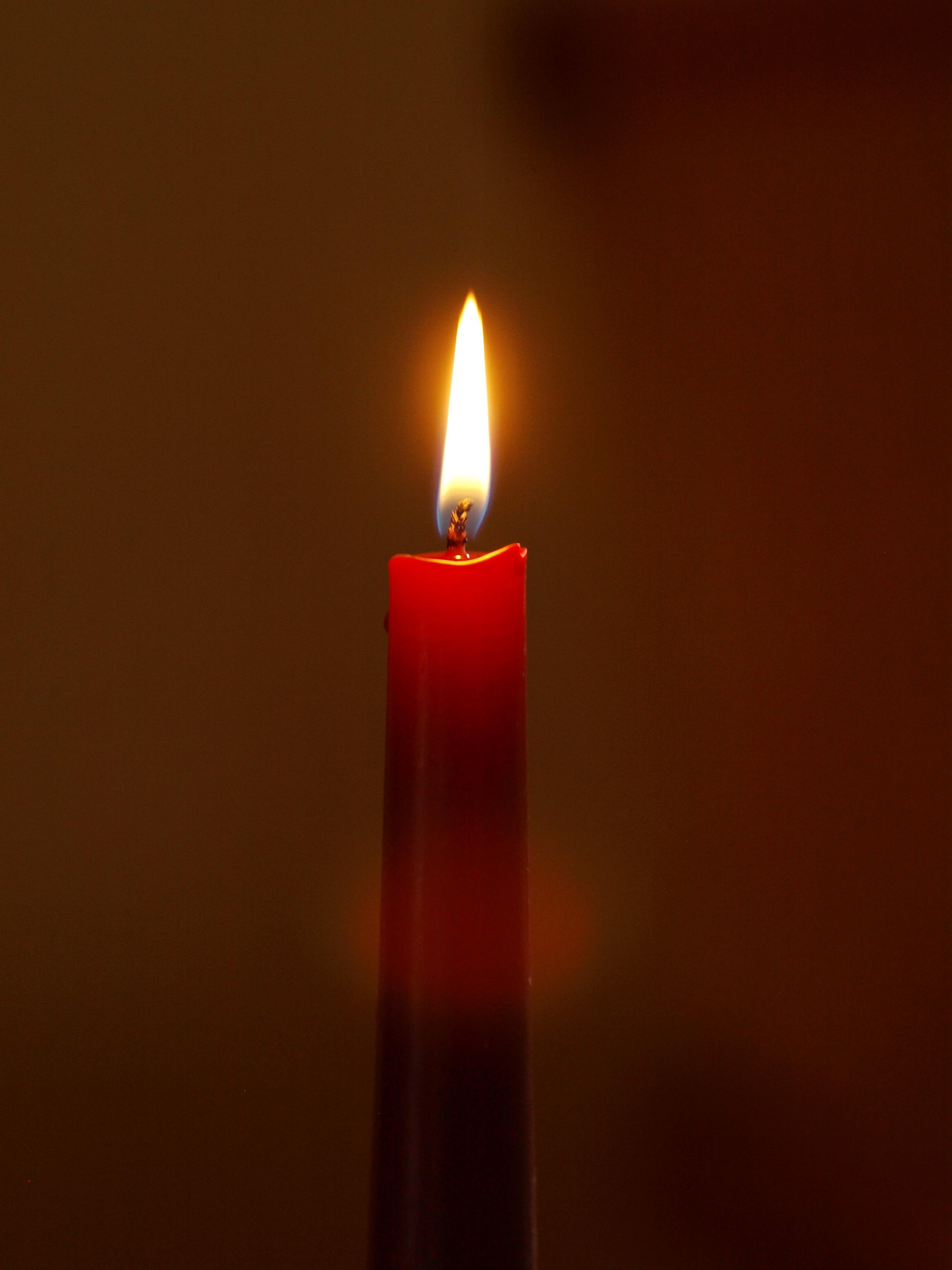 lighted red taper candle