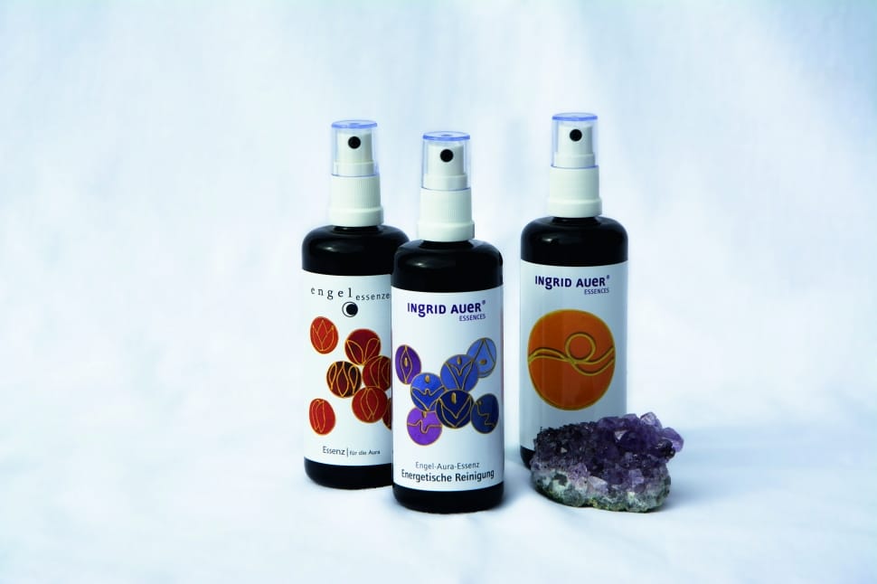 three purple and white labeled spray bottles preview
