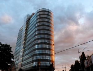architectural photography of mirror building under grey sky during day time thumbnail