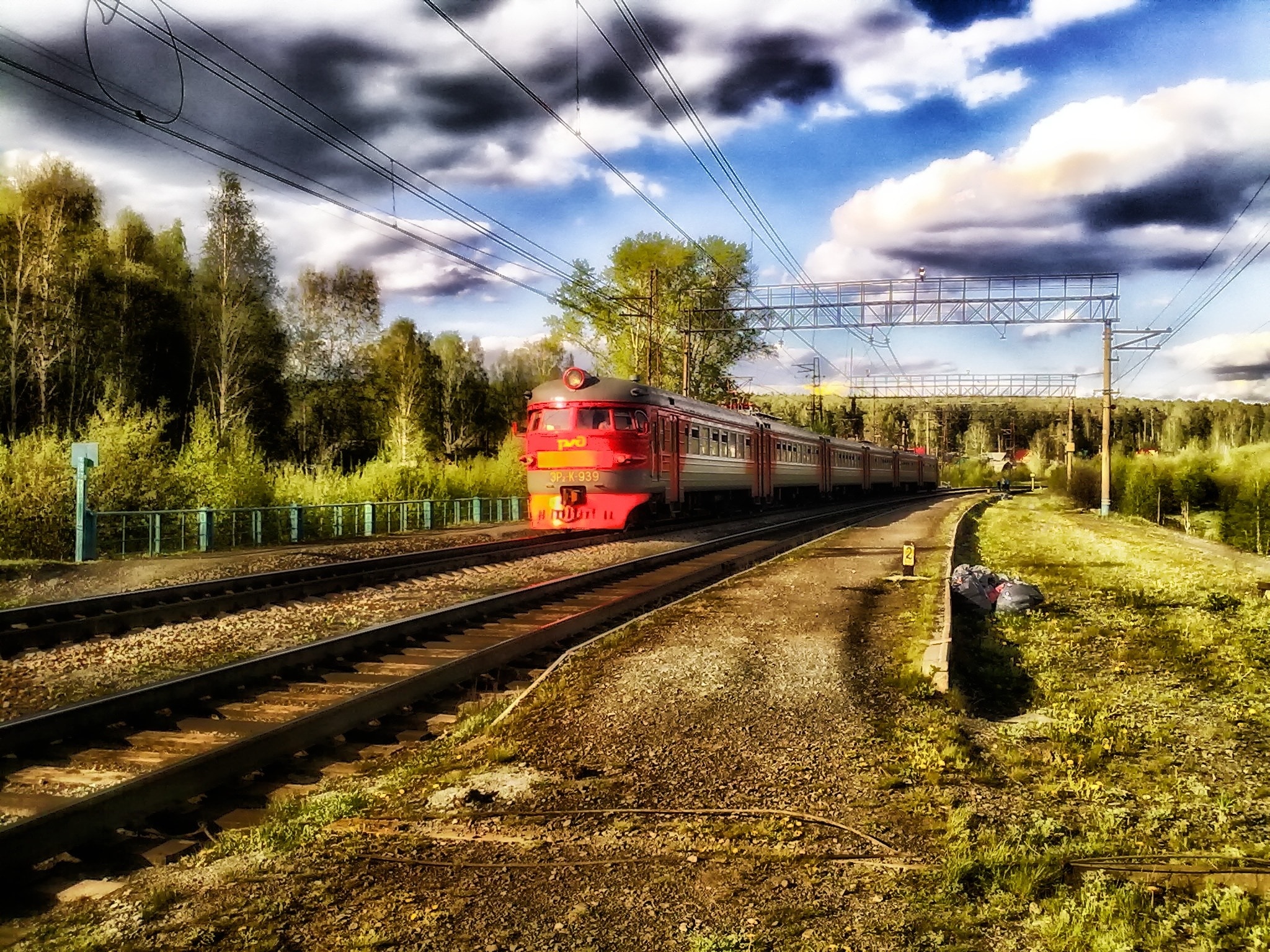 red steel train on rails during daytime