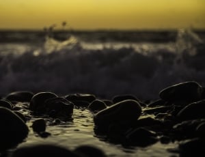 rocks next to body of water at sunset thumbnail