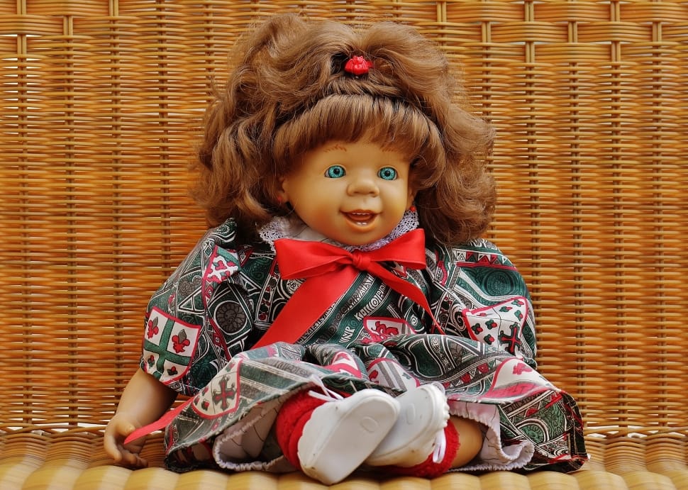 baby porcelain doll in red and green bow dress preview