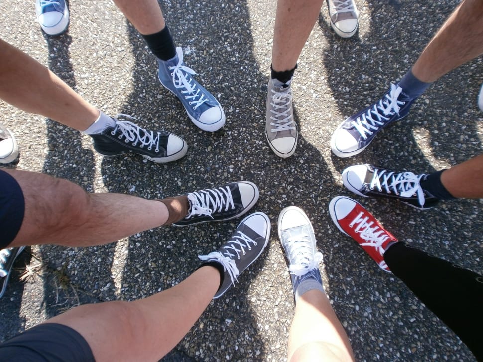 group of people wearing Converse All Star sneakers taking picture of sneakers preview