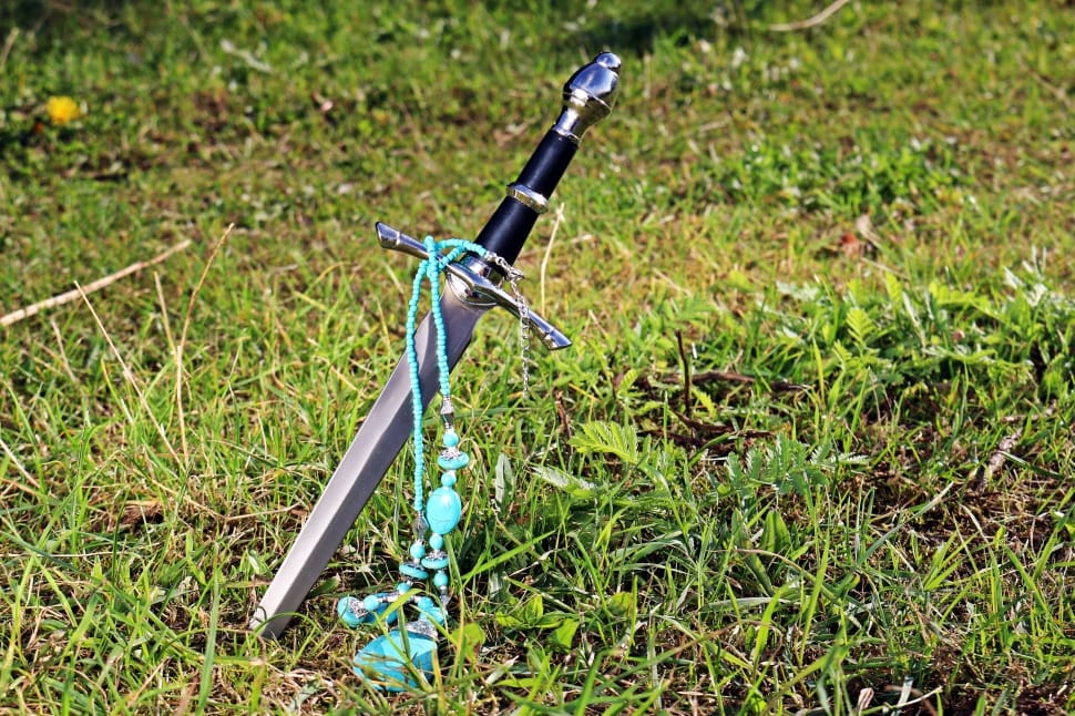 teal beaded necklace and black handled sword preview